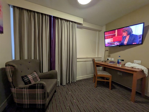 Image of a hotel room with a television
