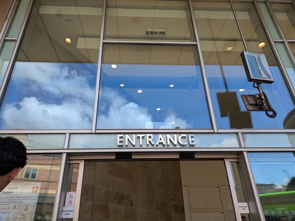 Image of entrance to - a glass door way with Entrance written above the door
