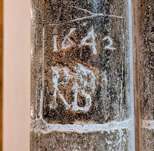 Image of a year and initials that have been carved into the stone walls by monks in 1642