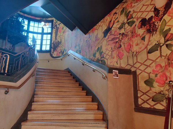 The main staircase, with a mural running alongside it