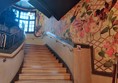 The main staircase, with a mural running alongside it