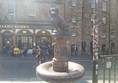 Image of the Greyfriars Bobby statue with the pub ib the background