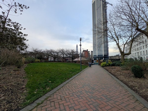 Image of walkway with a tower block in the background