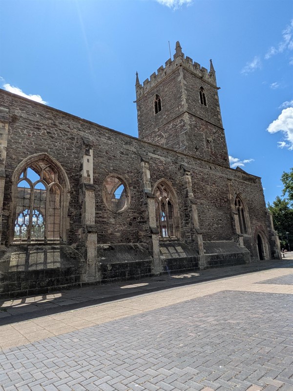 Image of the runs of  St. Peter's Church set against a blue sky with sparse clouds