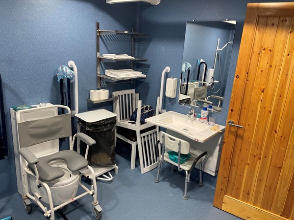 Wet room showing Clos-o-Mat toilet and height-adjustable sink (wheeled shower chair not included)