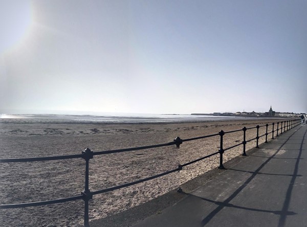 Flat Accessible promenade with railings alongside for safety.