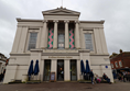 Front view of museum, a white rather grand building.