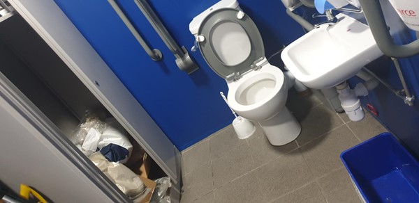 Picture of disabled toilet being used as a store cupboard