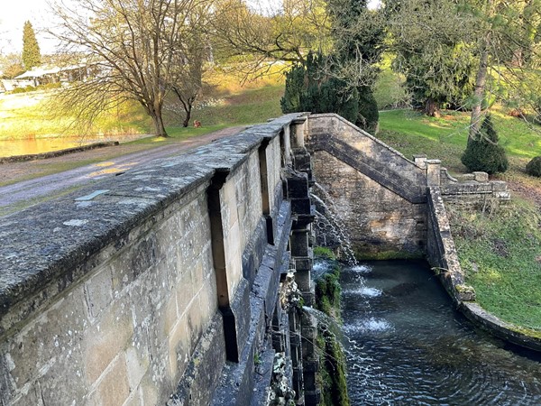 Impressive wall of the decorative carved frontage of the cascade below