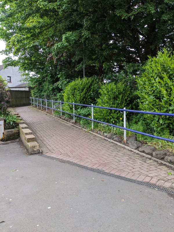 Image of dipped kerb leading up a pathway.