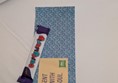 Image of a Curly Wurly Chocolate bar on the bed sheet on top of a slip of paper reading Sent with Soul