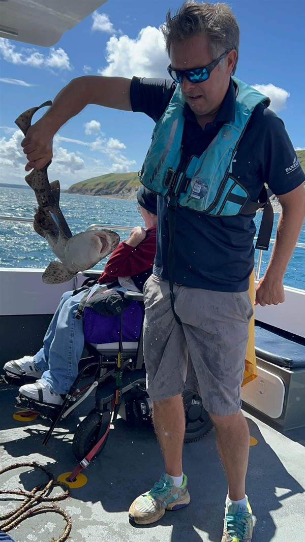 Image of a man with a basket of crabs.