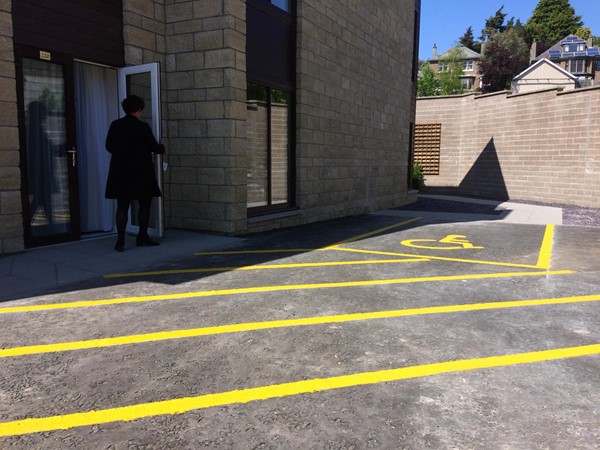 Accessible parking outside accessible bedroom and pathway to other rooms.
