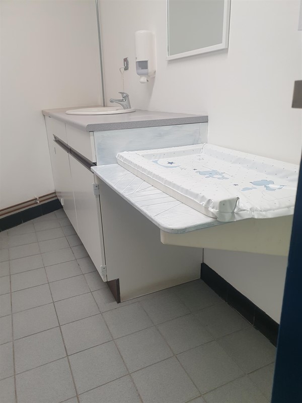 Baby changing room with room to roll under the changing table, the sink was just accessible to me in my low manual wheelchair but the soap was a struggle.