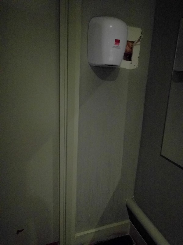 Hand dryer positioned much too high on the wall for most wheelchair users to reach, very thoughtless and silly.