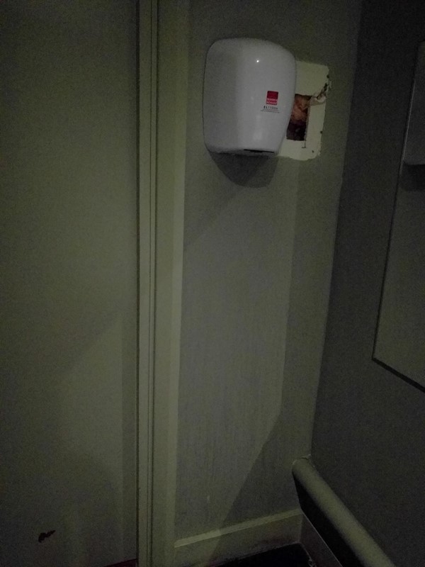 Hand dryer positioned much too high on the wall for most wheelchair users to reach, very thoughtless and silly.