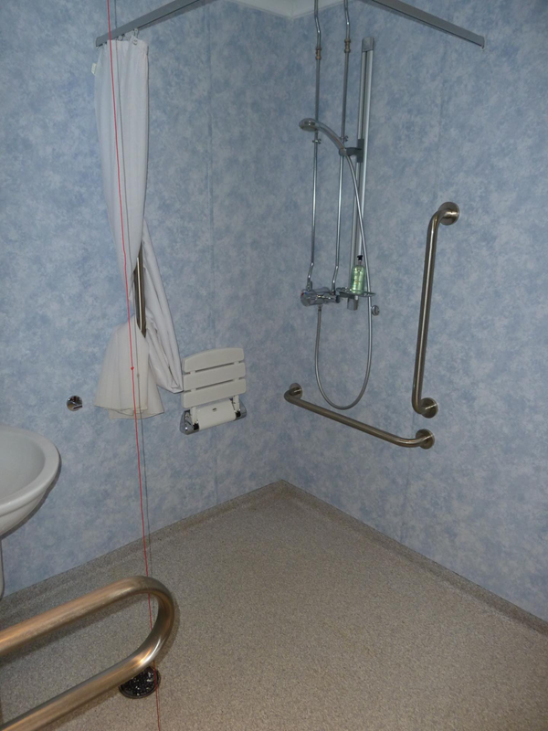 Wheel in shower with fold down seat. Fixed grabs