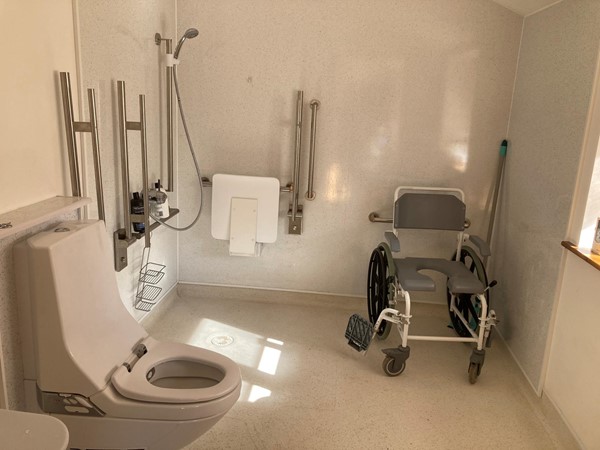 Wet room, with shower chair and ‘wash and dry’ toilet. Also has ‘rise and fall’ basin.