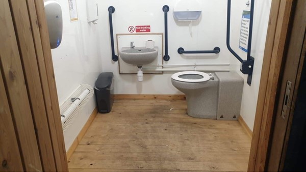 Image of the accessible toilet at the accessible parking area.