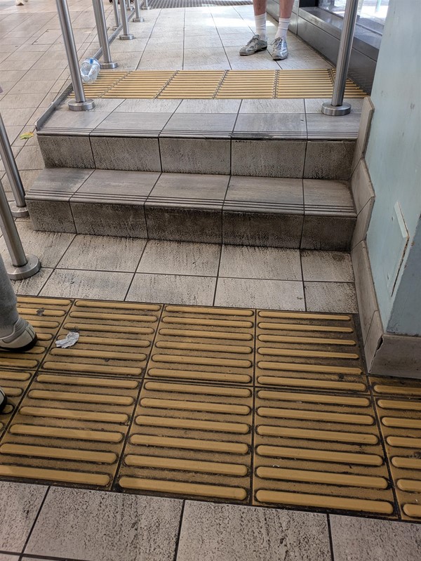 Image of tactile marking and rails at two steps