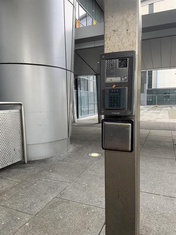 image of a pillar with the door open button and an intercom at the front entrance of Queen Elizabeth University Hospital