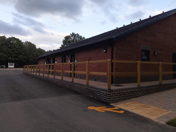 Wide paved path going around the facilities block.