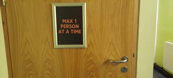 Picture of a sign saying "max 1 person at a time"