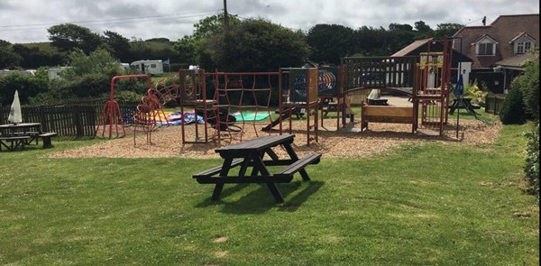 Outside seating and childrens play area - looking towards the pub