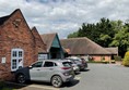 Picture of the front of the hotel and car park