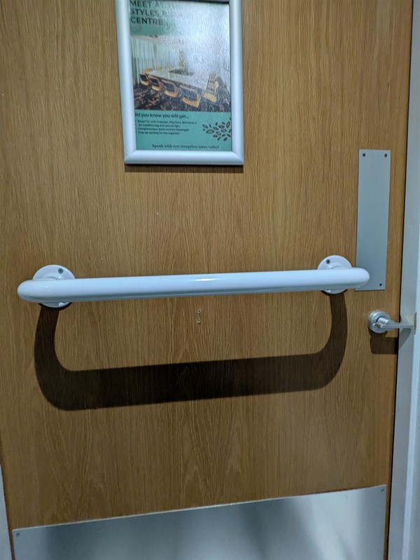 Image of grabrail on accessible toilet door