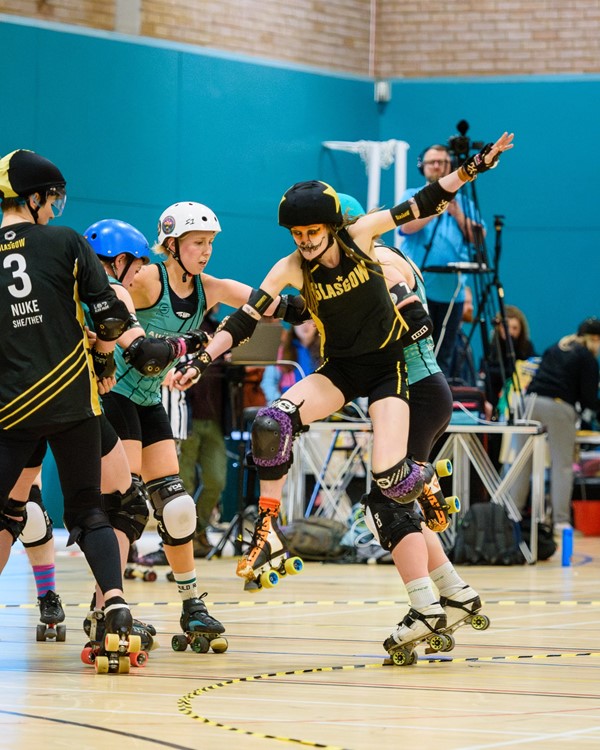 Fearless Fox from Glasgow Roller Derby jumping over skaters to get past and score points.
