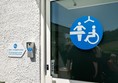Door of CP Toilet with silver keypad on the left.