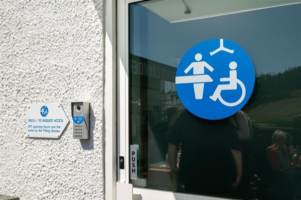Door of CP Toilet with silver keypad on the left.