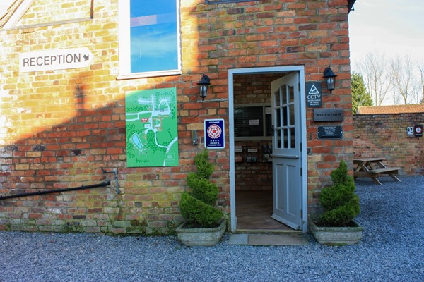 Reception with a large lip up and very narrow door, which is not fully open as the door sticks on the floor.