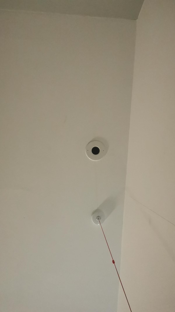 View of a red emergency cord coming out of the ceiling