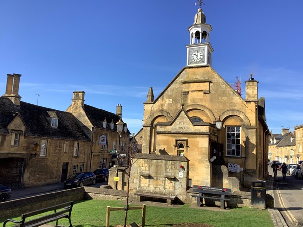 Taking your scooter or wheelchair, ride alongside the hall with its clock tower