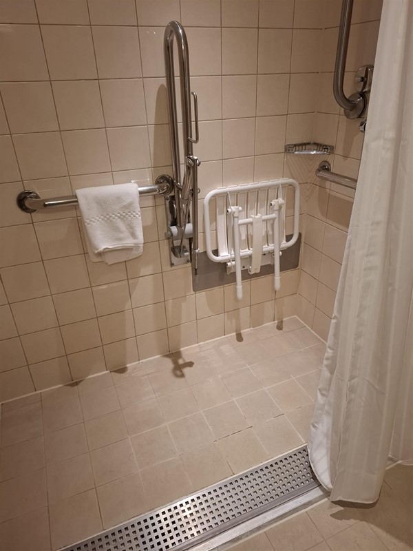 The plastic floor strip can't be seen in this photo. Water drained away quickly.a lower fitting for the shower head would have been useful as I could not budge the riser head holder. The cabin steward provided extra large pool bath sheet towels as I found the standard ones too small