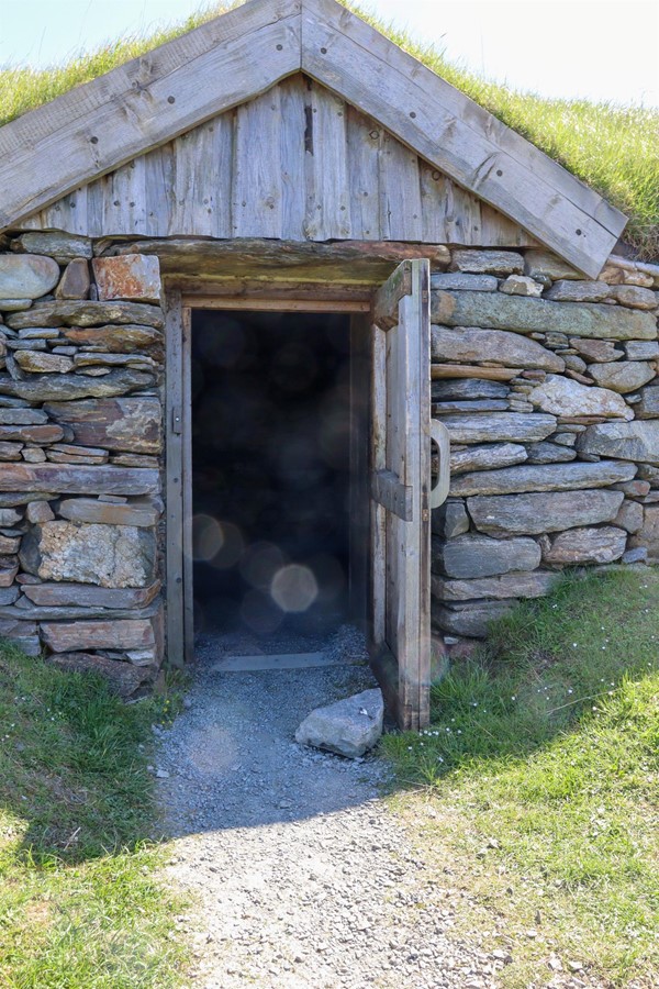 Door to the longhouse with stone blocking the path.