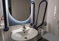 Image of shower, sink and mirror in the accessible toilet of a hotel room
