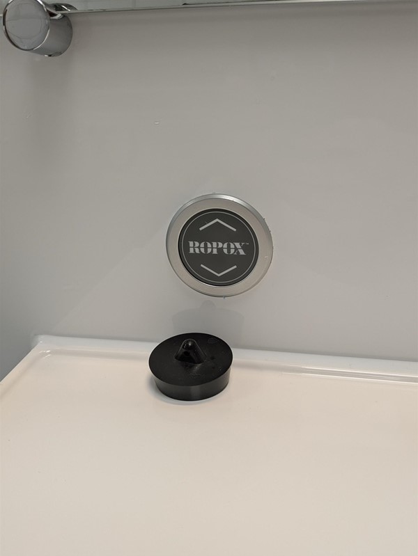 Image of button for adjustable sink