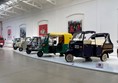 Image of a row of vehicles on display.
