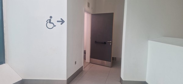 Signage to accessible loo, with door that opens outwards.