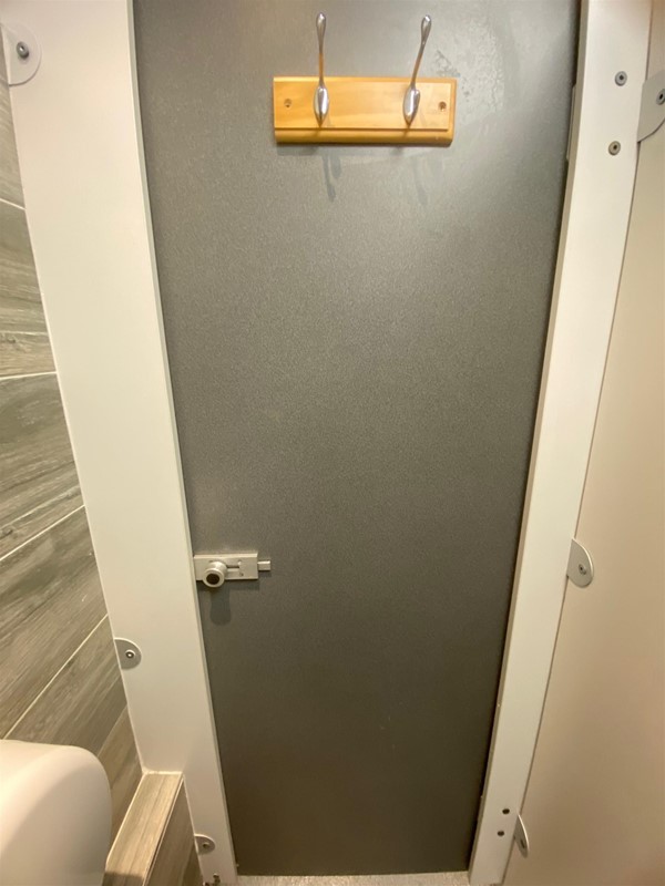 Image of hooks on the inside of a toilet door