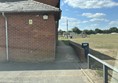 View of the Village Hall, parking from a car