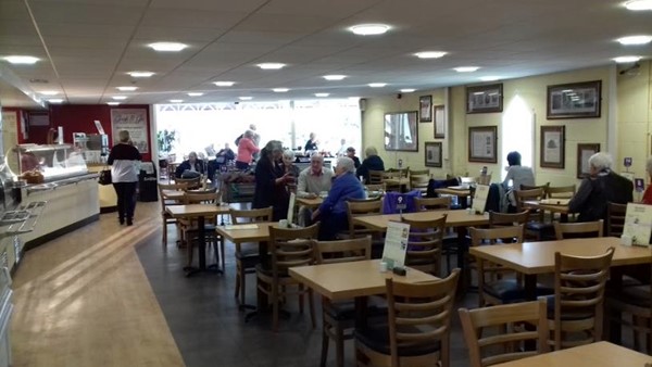 The café. Where the big windows are is a big sunroom seating area which has a lot more room to manoeuvre wheelchairs around in.