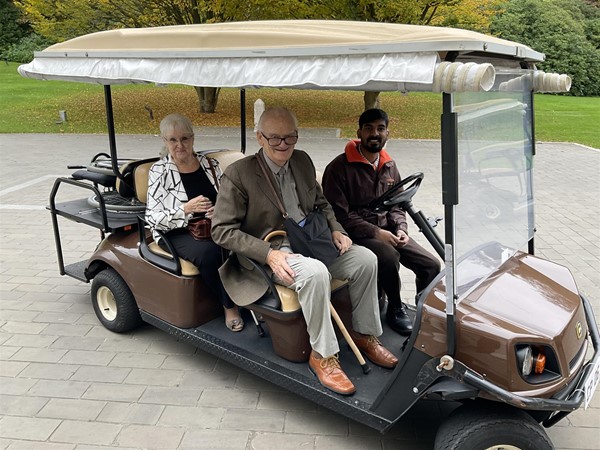 Image of people in a golf cart