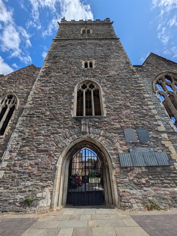Image of the ruins of  St. Peter's Church set against a blue sky with sparse clouds