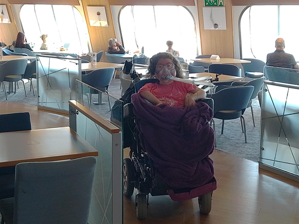 Image of a wheelchair user in a ferry cafe