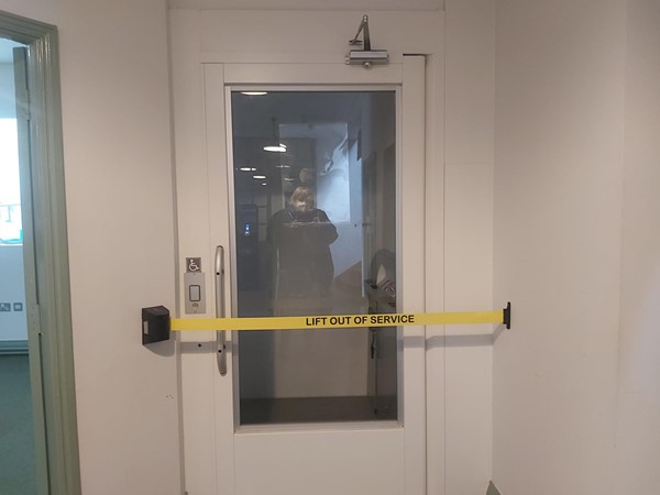 Lift with "lift out of service" tape