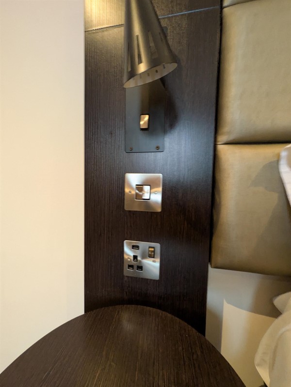 Image of switches and sockets to the side of the bed